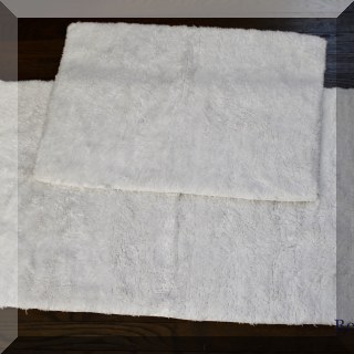 D88. Pair of white shag bath mats.